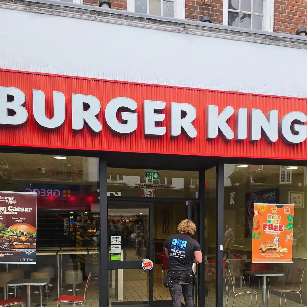 Essex Door & Window Repairs engineer at a Burger King shopfront entrance