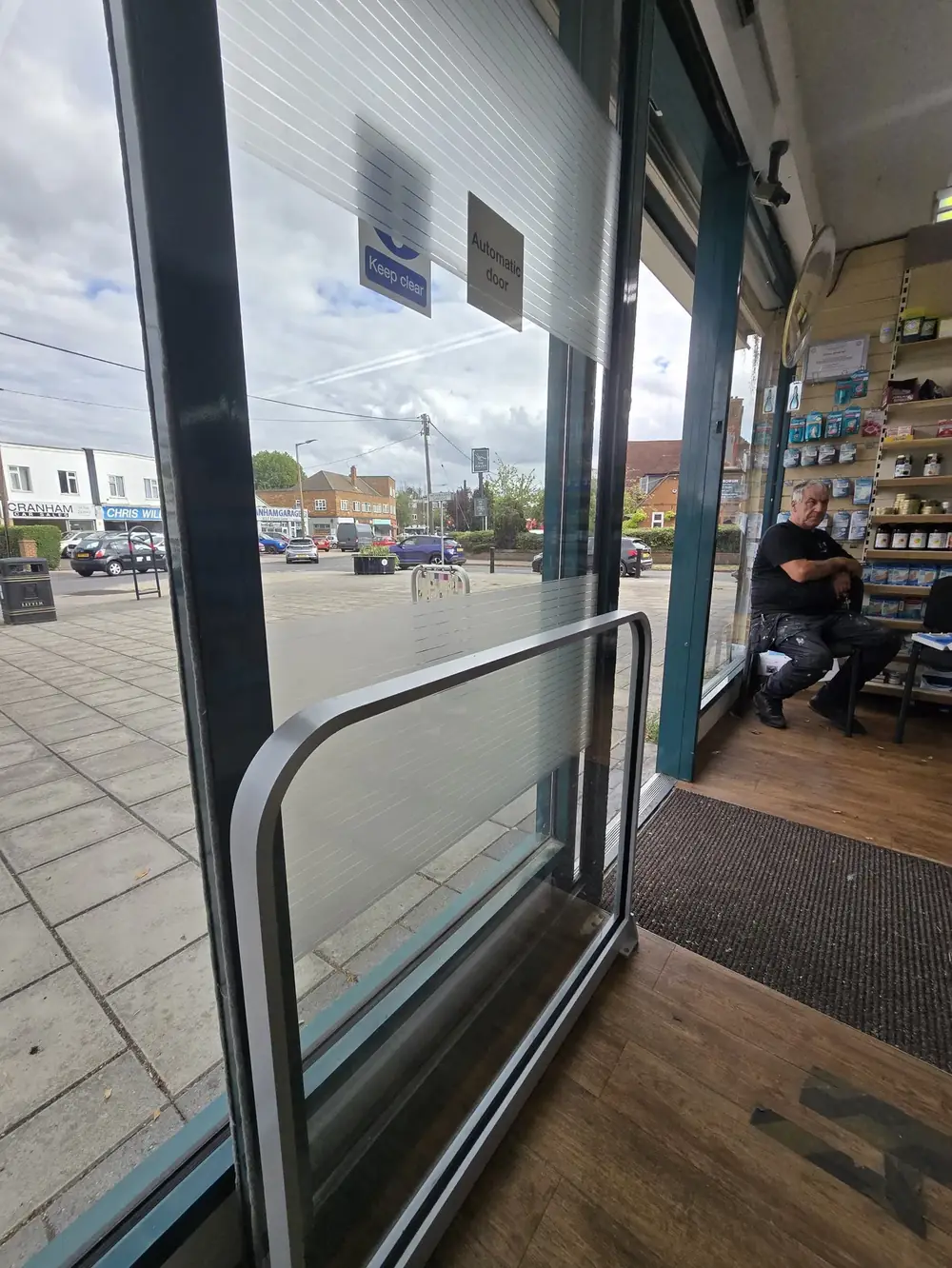 Automatic sliding door at a pharmacy with safety guard rail